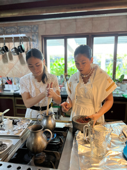 The Chocolate Queen, Ms. Raquel Choa, and her daughter Angelie Choa prepare the spicy chocolate with chili.